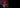 Junger Gamer mit Headset streamt an einem Laptop mit RGB-Beleuchtung im abgedunkelten Raum.