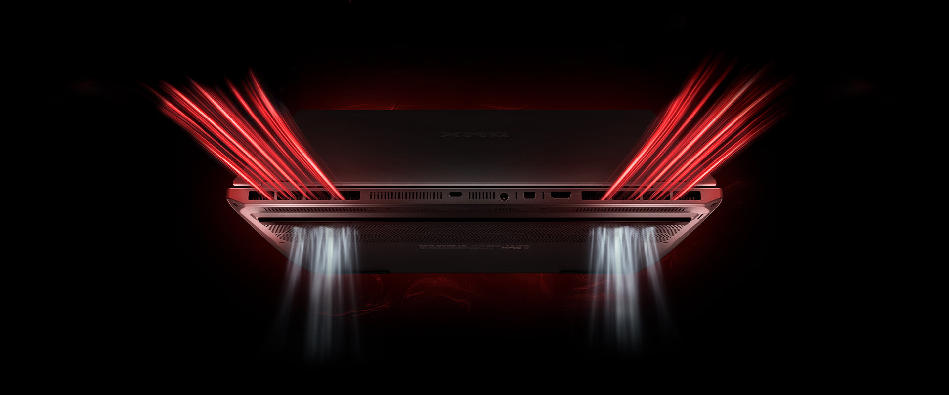 Rückseite eines Gaming-Laptops mit symbolisierten roten Lichtstrahlen an den Lüftungsschlitzen