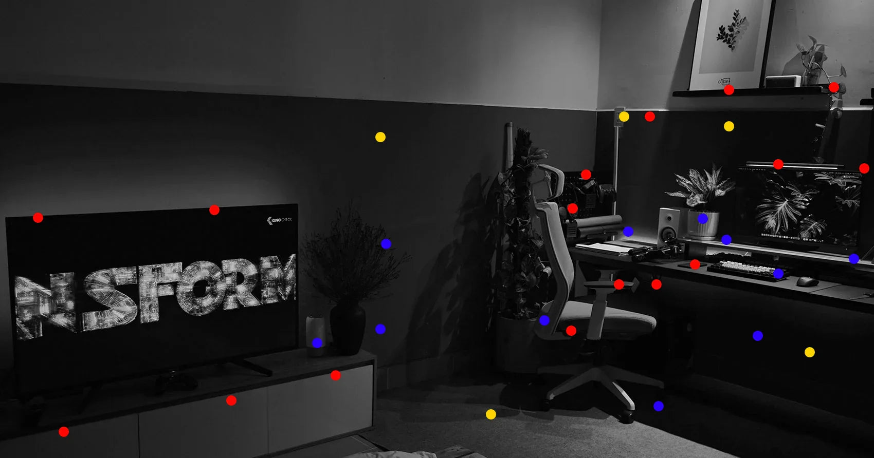 Modernes Gaming-Setup mit beleuchtetem Monitor, Peripherie und großem Bildschirm im dunklen Raum
