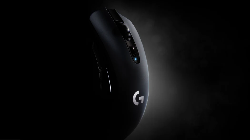 Schwarze Logitech Gaming-Maus mit beleuchtetem Logo im abgedunkelten Raum