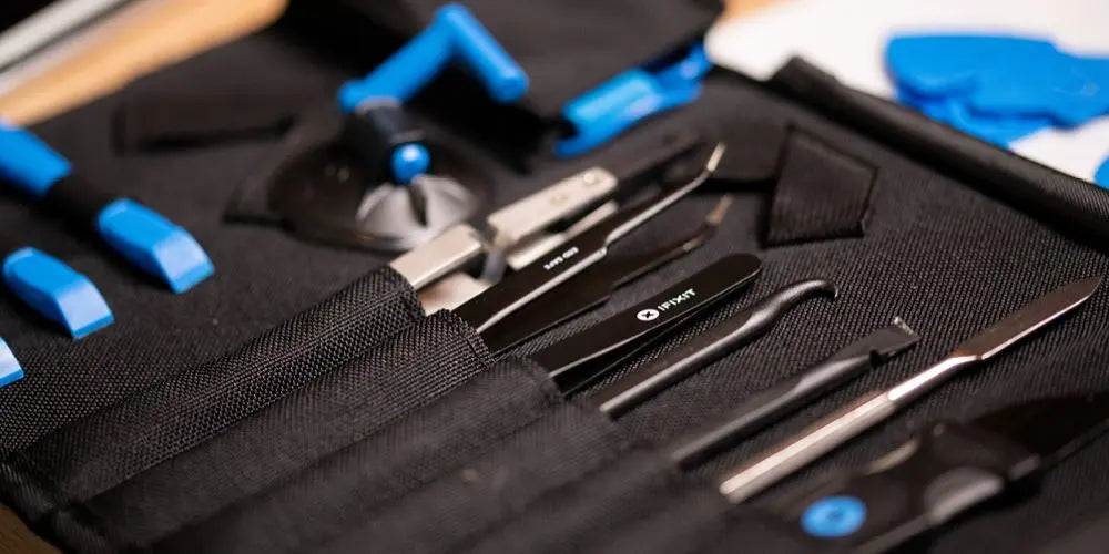 Professionelles iFixit Reparaturwerkzeug-Set mit Pinzetten, Hebeln und Spezialwerkzeugen für IT-Hardware in einer Tasche.